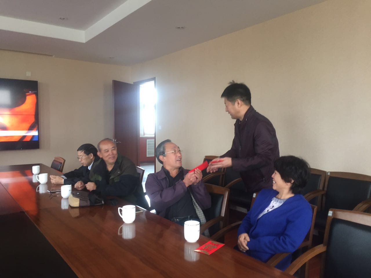 工会主席马建文代表院领导班子向老专家发放慰问金.jpg